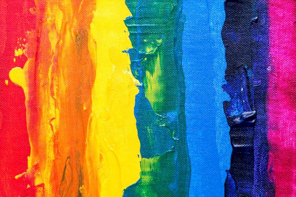 A vibrant abstract painting with thick vertical stripes of rainbow colors: red, orange, yellow, green, blue, and purple.