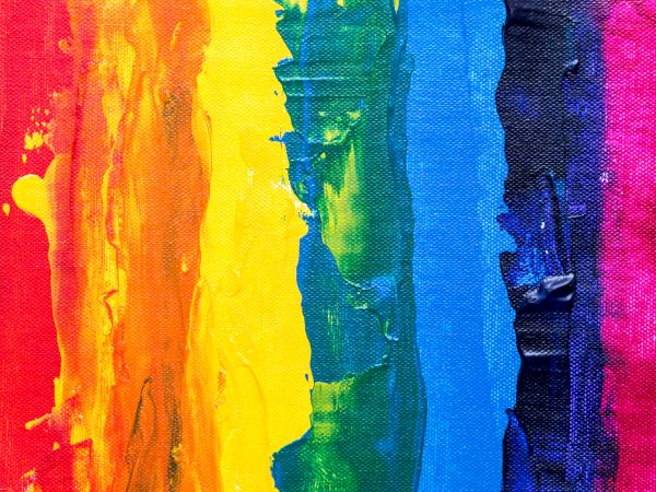 A vibrant abstract painting with thick vertical stripes of rainbow colors: red, orange, yellow, green, blue, and purple.